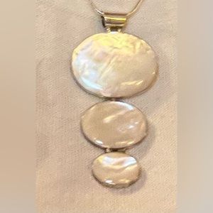 Silver tone and mother-of-pearl pendant necklace on 16”silver tone snake chain.